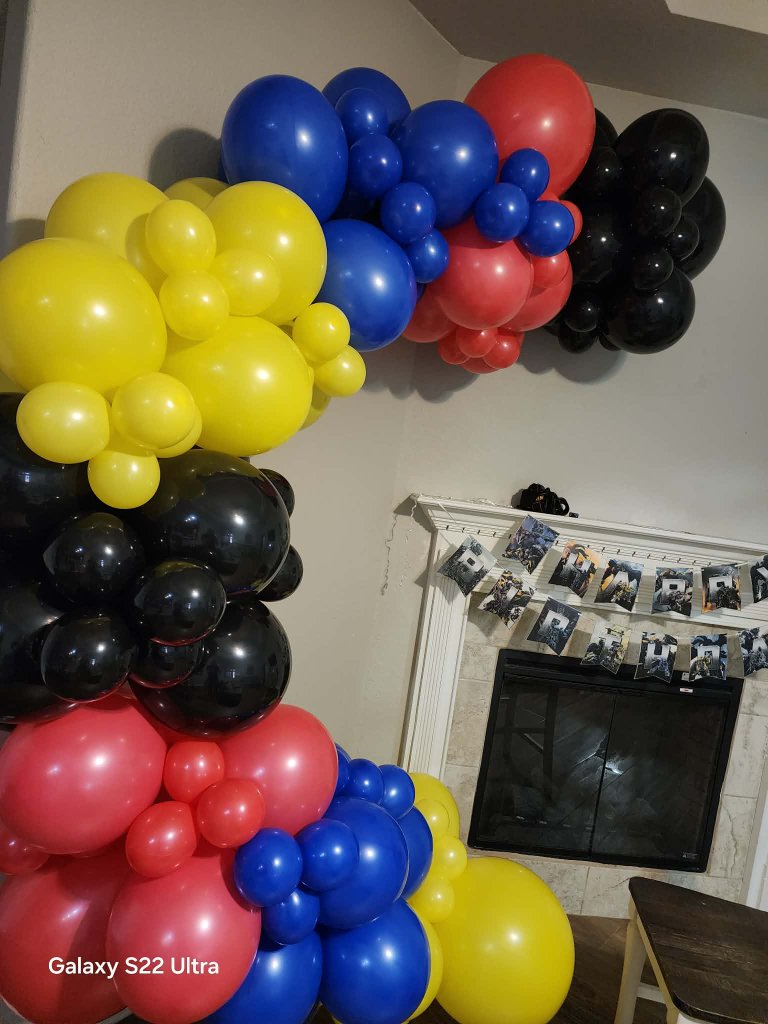 Red, blue, yellow and black corner garland beside a photo banner